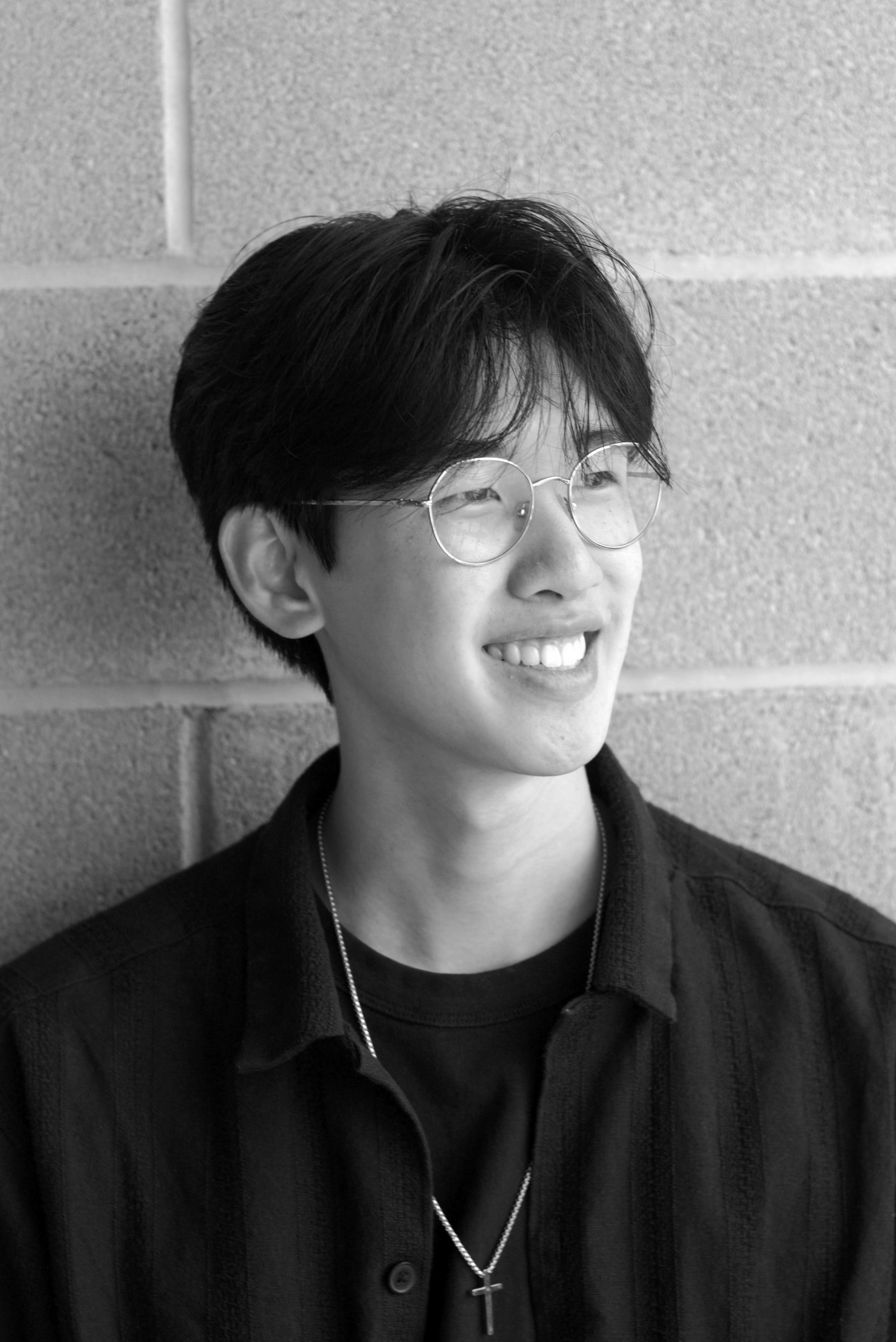 Richard Lin smiling in front of a brick wall